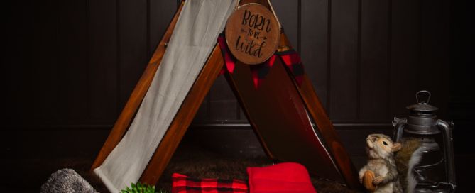 a prop set that features a little newborn tent and other camping equipment