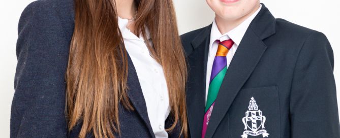 a brother and sister pose together for professional studio school photos