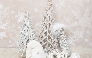a festive prop set with silver trees and white decorations