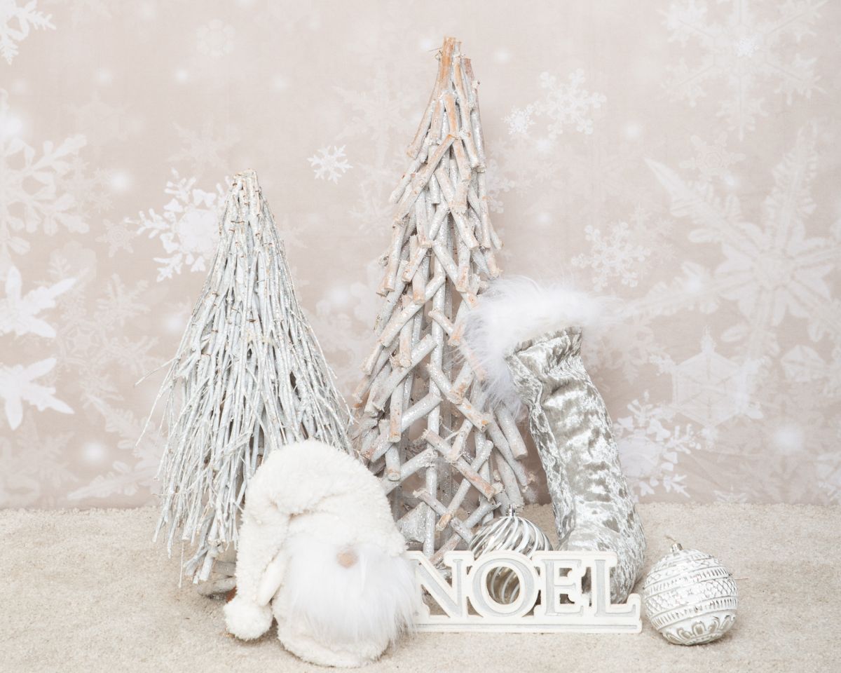 a festive prop set with silver trees and white decorations