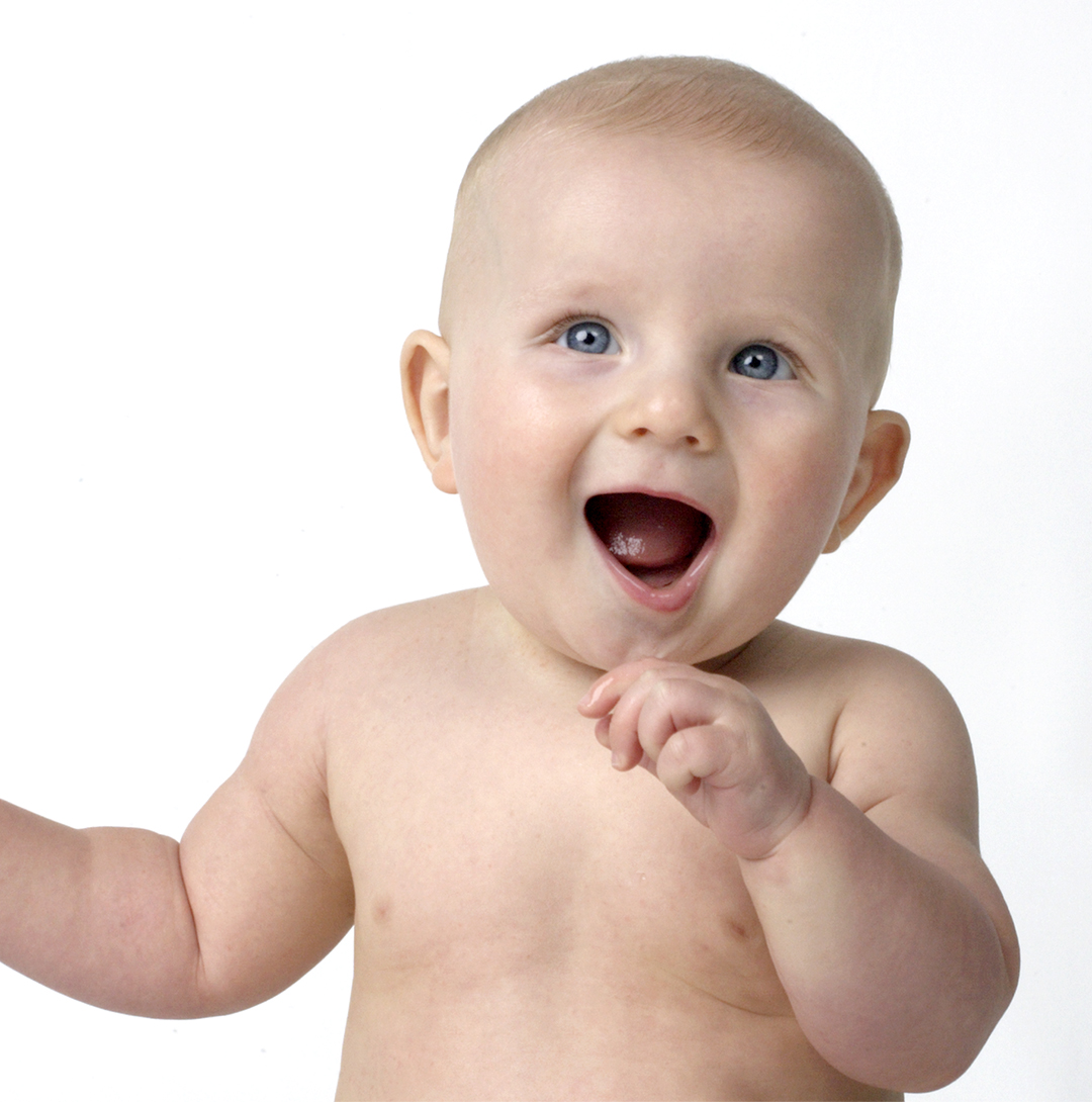 a little boy smiling for the camera against a white background