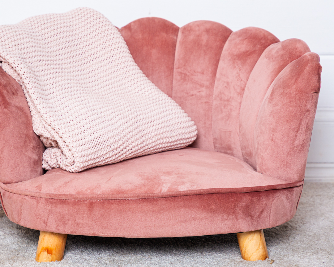 a pink chair with a matching pink blanket