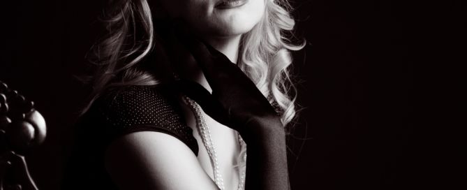 a black and white vintage styled image of a woman wearing long gloves