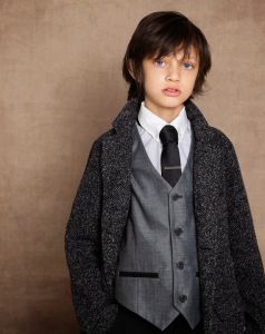 A young boy photographed in a suit in a fine art portrait session