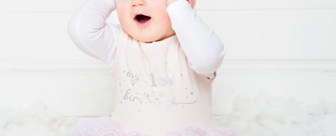 a little girl looking amazed that she gets whole cake