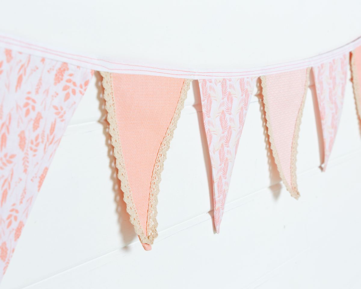 a string of peach bunting finished with vintage style lace