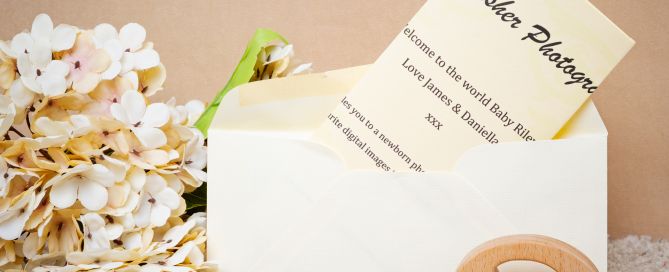 A gift voucher for a photo shoot styled with cream flowers and a small toy
