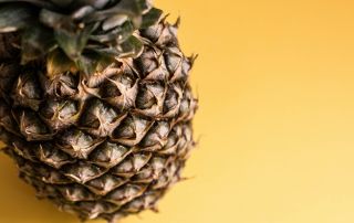 a picture of a pineapple against a yellow background