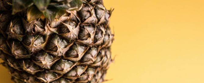 a picture of a pineapple against a yellow background
