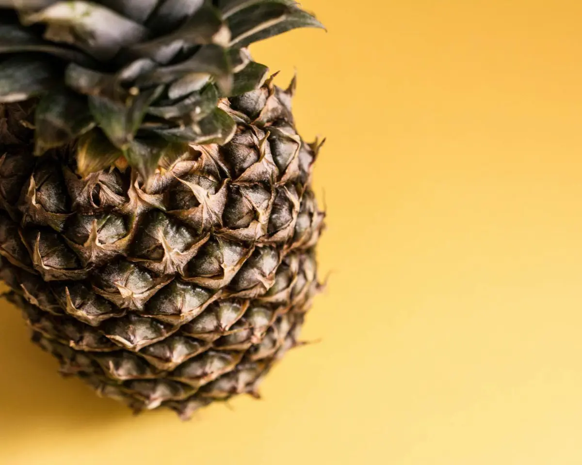 a picture of a pineapple against a yellow background