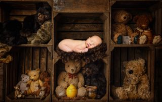 a newborn sleeping on a dark background in a digital composite