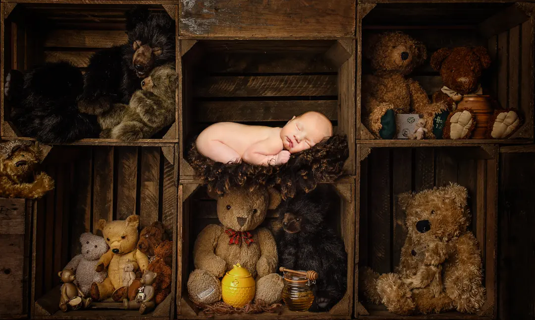 a newborn sleeping on a dark background in a digital composite
