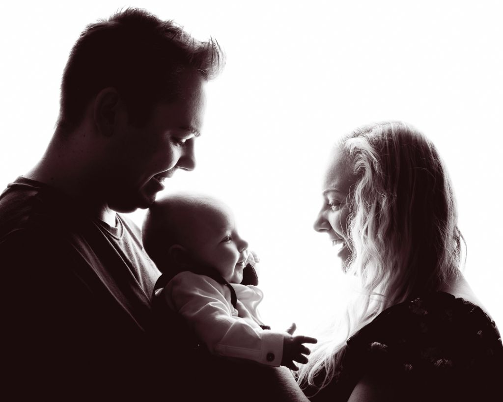 Family Portrait Photo Shoot East Grinstead West Sussex a backlit black and white image of a family smiling