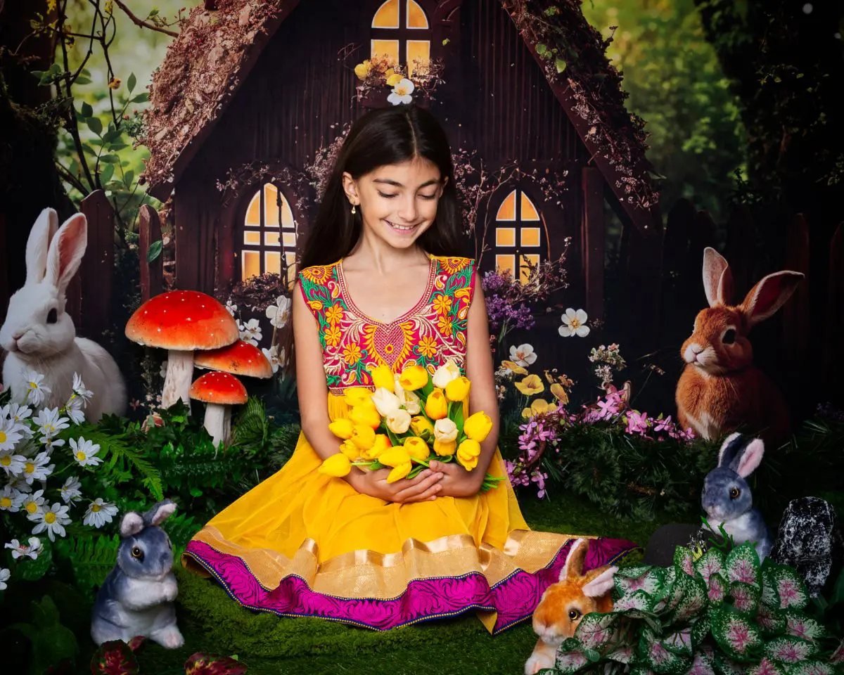 a girl poses in a yellow dress at an easter mini shoot