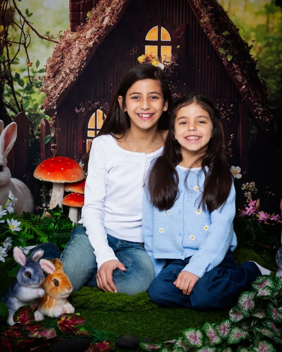 Two girls sit together at an easter mini shoot