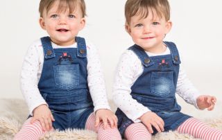 Twins dressed in denim smile for the camera