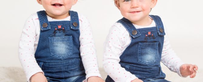 Twins dressed in denim smile for the camera