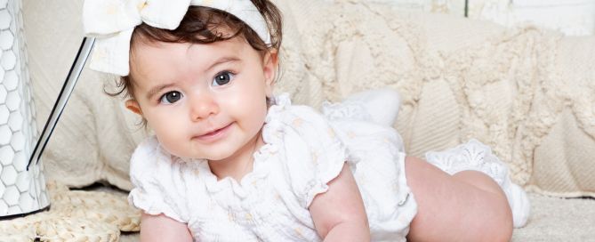 a little girl with dark hair and brown eyes poses in a Boho Styled studio set
