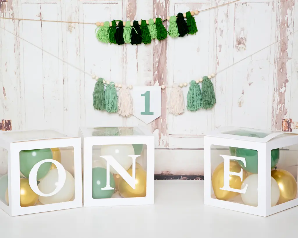 A set up in the studio with 1 themed tassels and balloons in green and gold