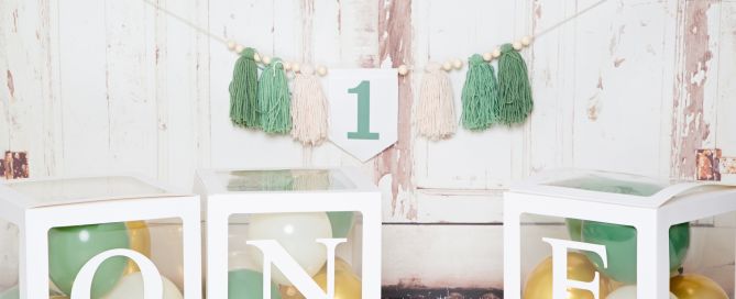 A set up in the studio with 1 themed tassels and balloons in green and gold