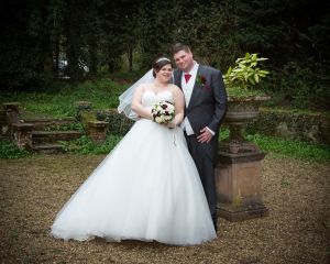 a couple pose at Gatwick Manor on their wedding day