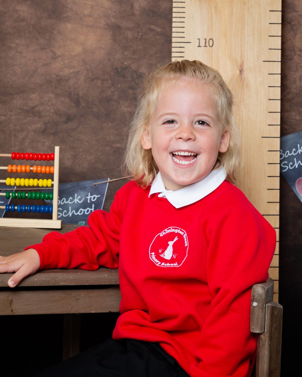 a little boy in a red jumper laughs at Starting School Photo Shoot Event West Sussex Crawley Down