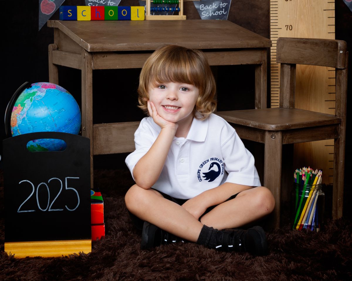 a little boy sits on the floor at Starting School Photo Shoot Event West Sussex Crawley Down