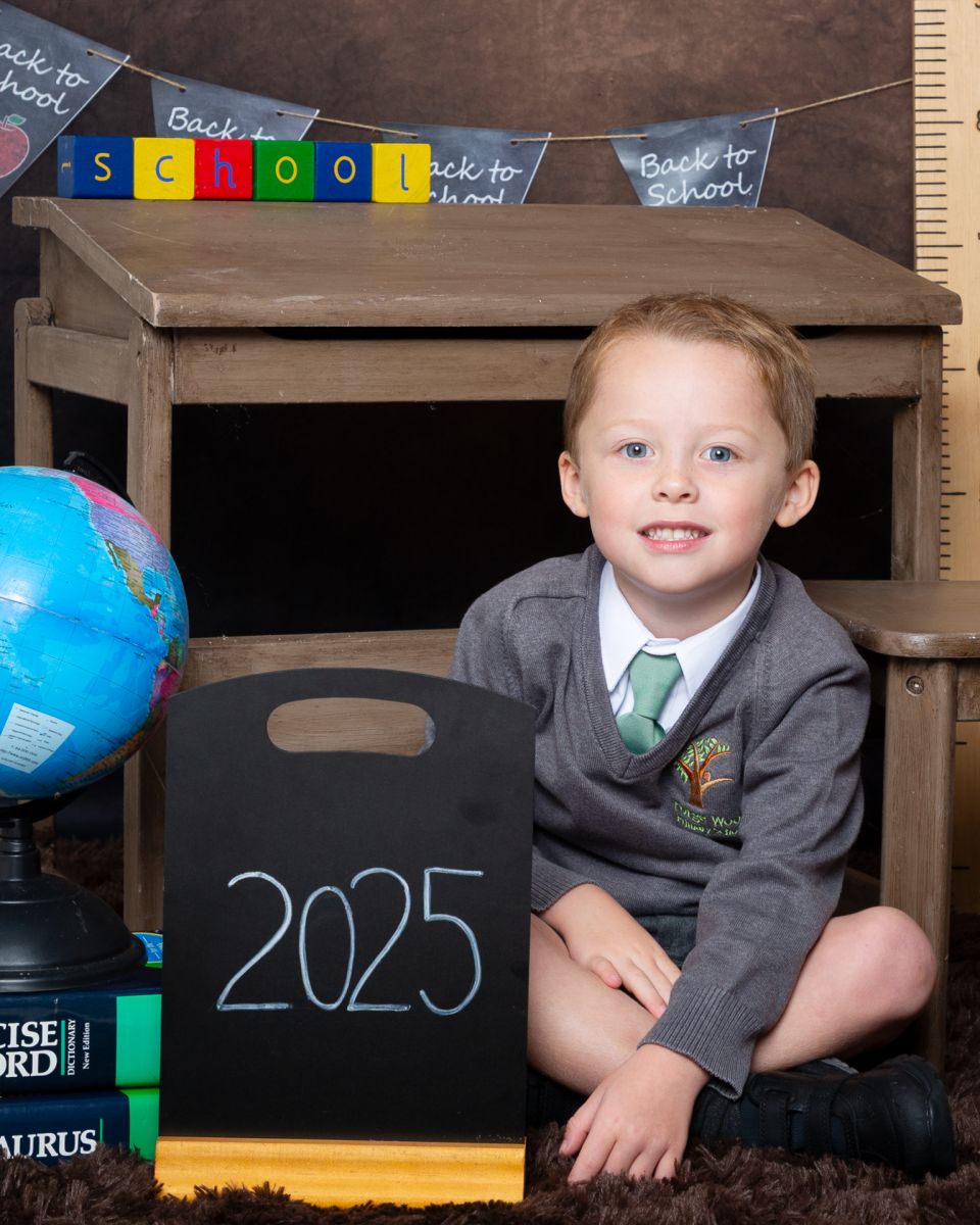 a little boy poses at Starting School Photo Shoot Event West Sussex Crawley Down