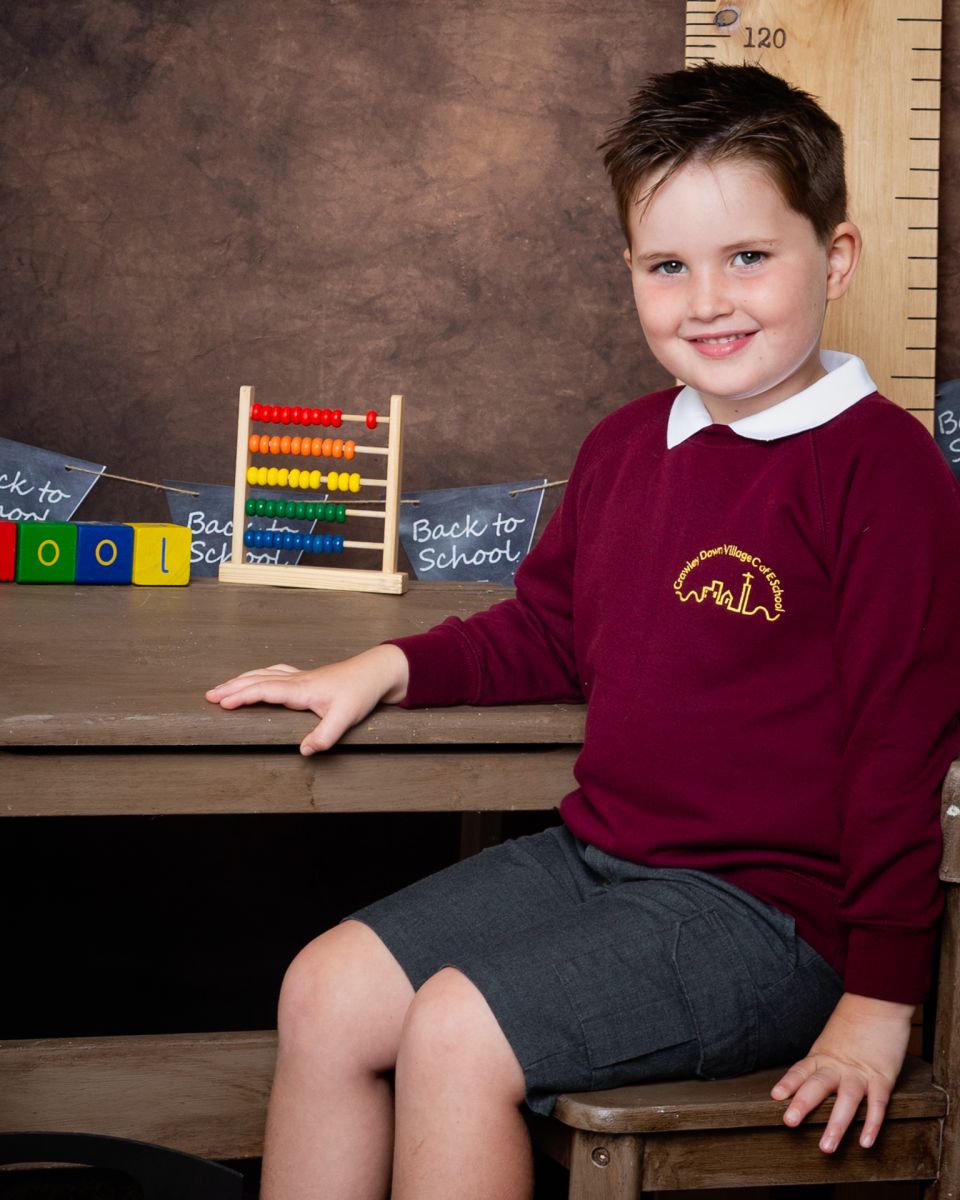 a little boy in a burgundy jumper laughs at Starting School Photo Shoot Event West Sussex Crawley Down