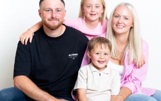 A family pose together in pink and black outfits