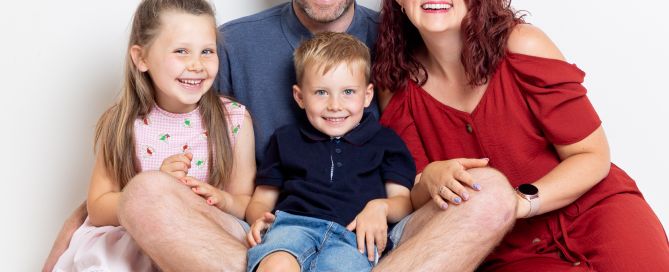 A family laugh at a professional photo shoot