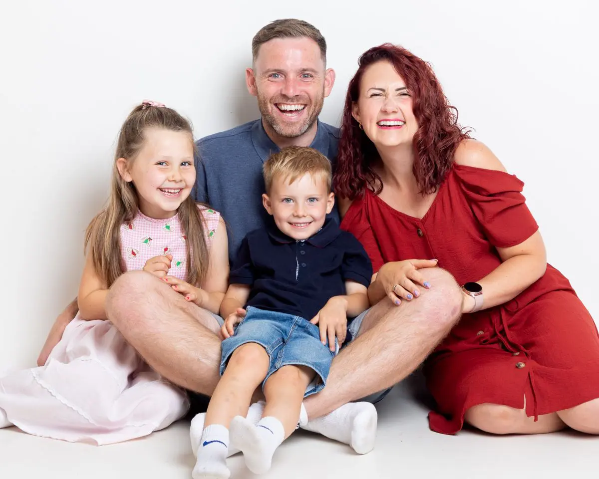A family laugh at a professional photo shoot