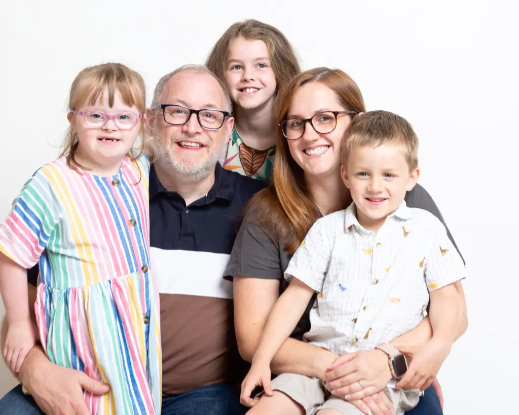 a family of three children and their parents pose for a professional photo at my west sussex studio