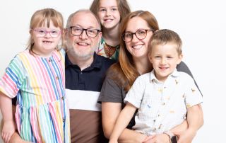 a family of three children and their parents pose for a professional photo at my west sussex studio