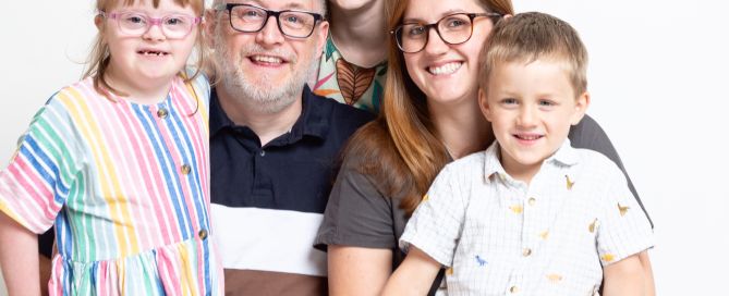 a family of three children and their parents pose for a professional photo at my west sussex studio