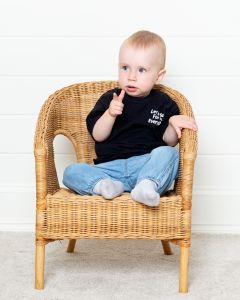 a little boy pulling a finger gun pose at a professional photo shoot