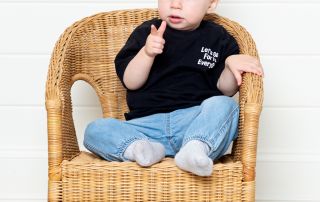 a little boy pulling a finger gun pose at a professional photo shoot