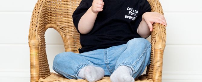 a little boy pulling a finger gun pose at a professional photo shoot