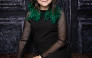 A girl with rainbow hair poses at a professional photo shoot