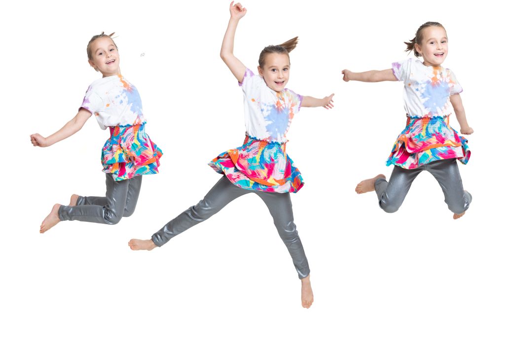 a composite image of a little girl jumping into the air