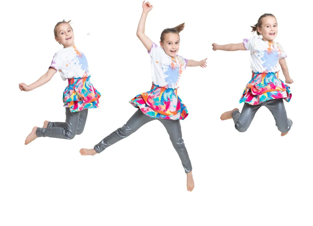a composite image of a little girl jumping into the air
