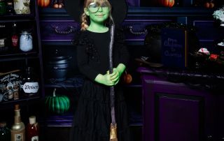 a little girl dressed as Elphaba at a halloween photo shoot in west sussex