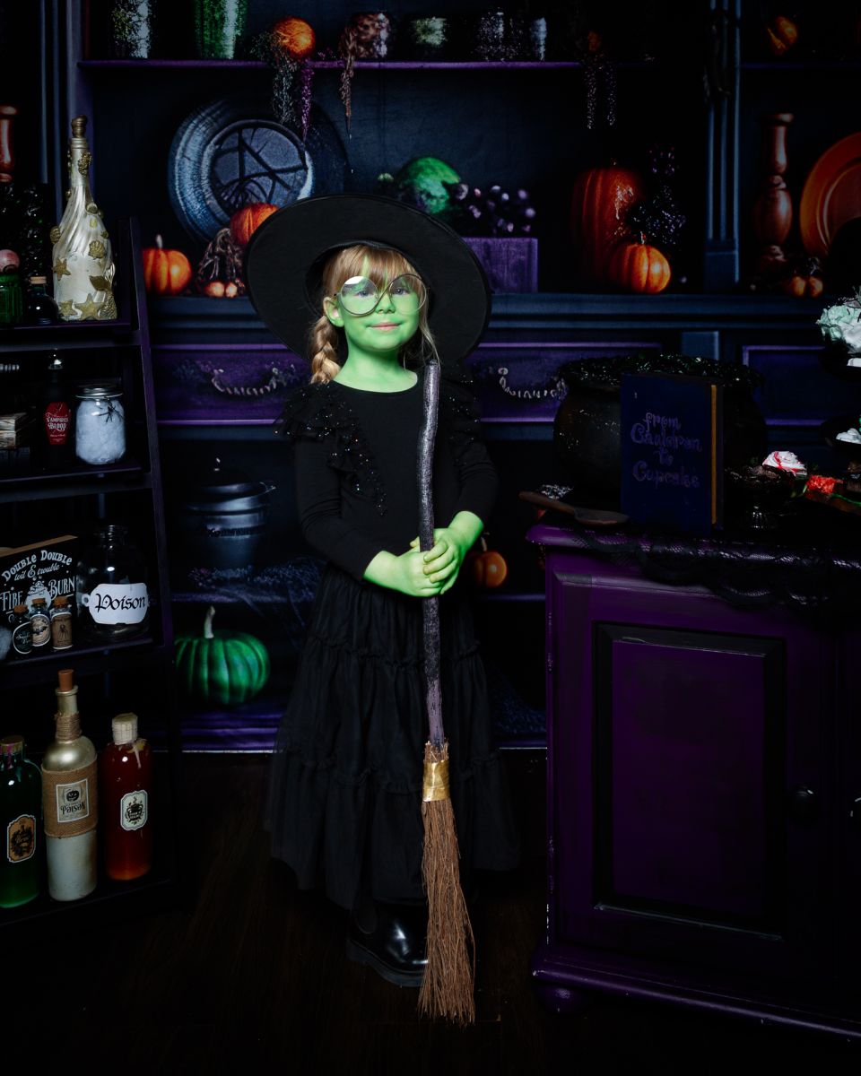 a little girl dressed as Elphaba at a halloween photo shoot in west sussex