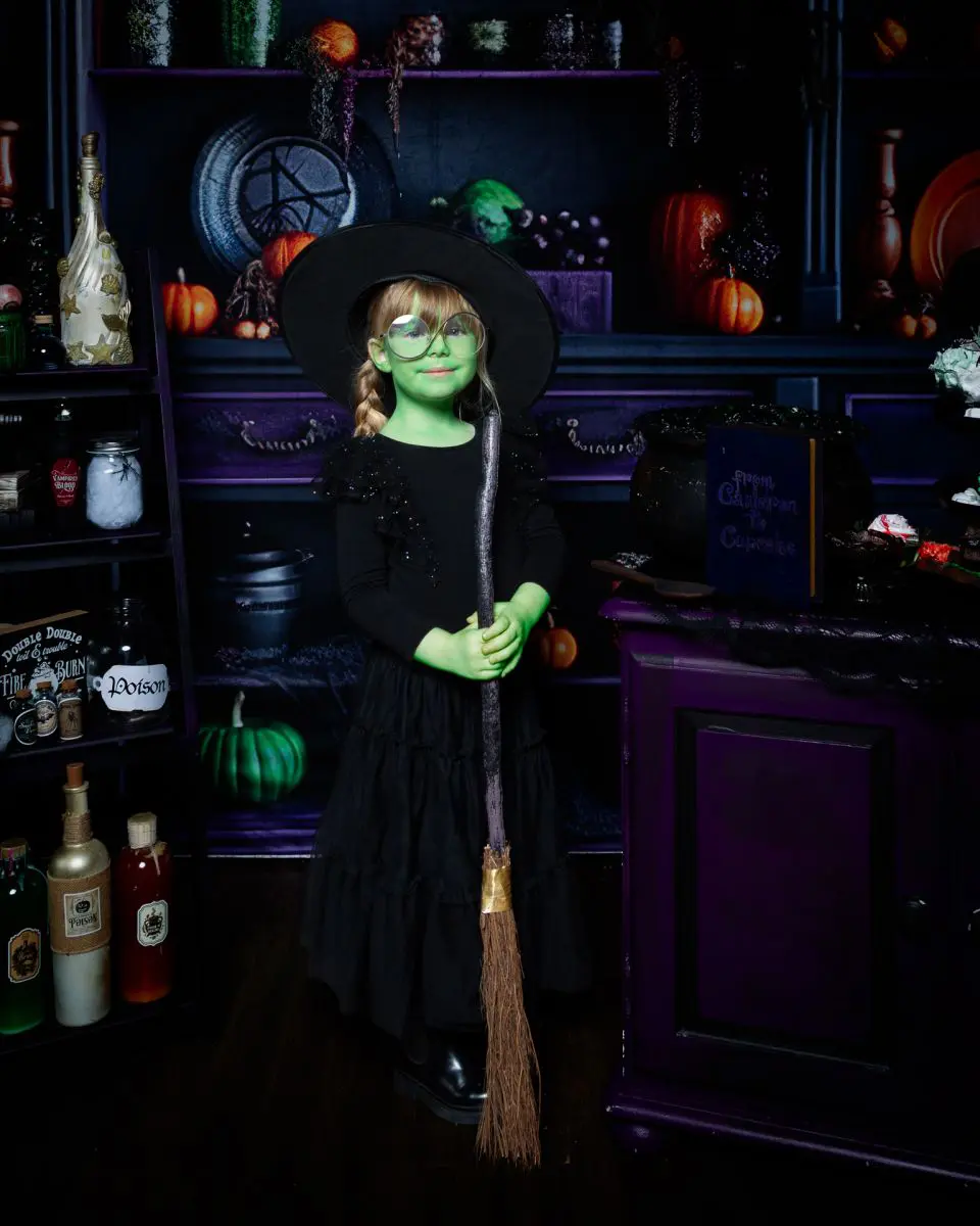 a little girl dressed as Elphaba at a halloween photo shoot in west sussex