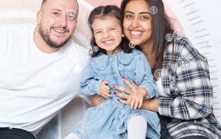 A family pose in the studio for a bubble photo recreation