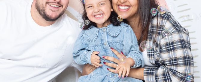 A family pose in the studio for a bubble photo recreation