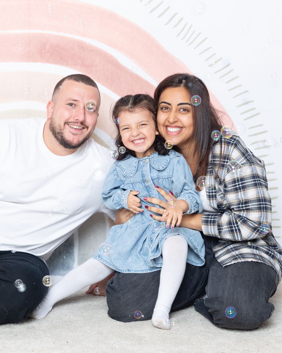 A family pose in the studio for a bubble photo recreation