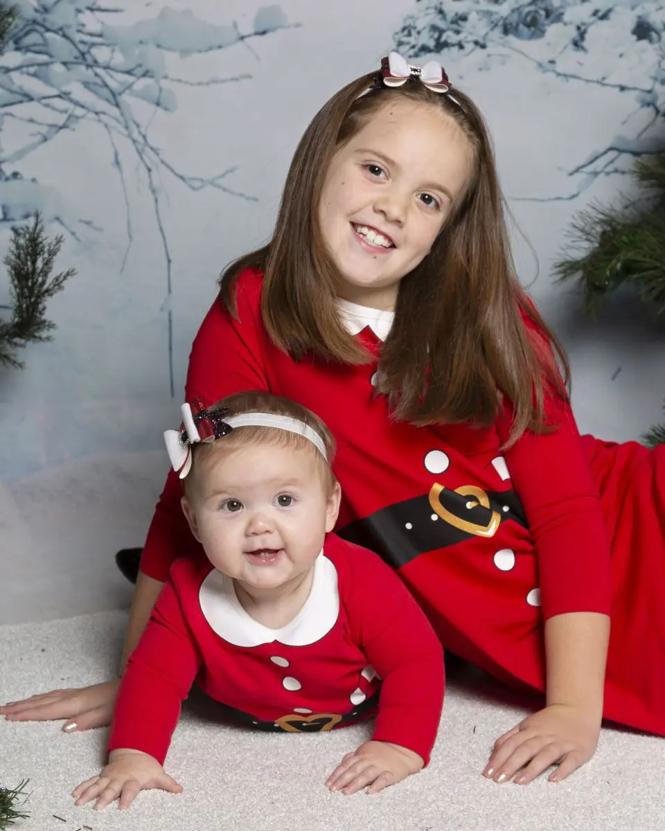 Sisters pose for photos at a Christmas Photo Shoot