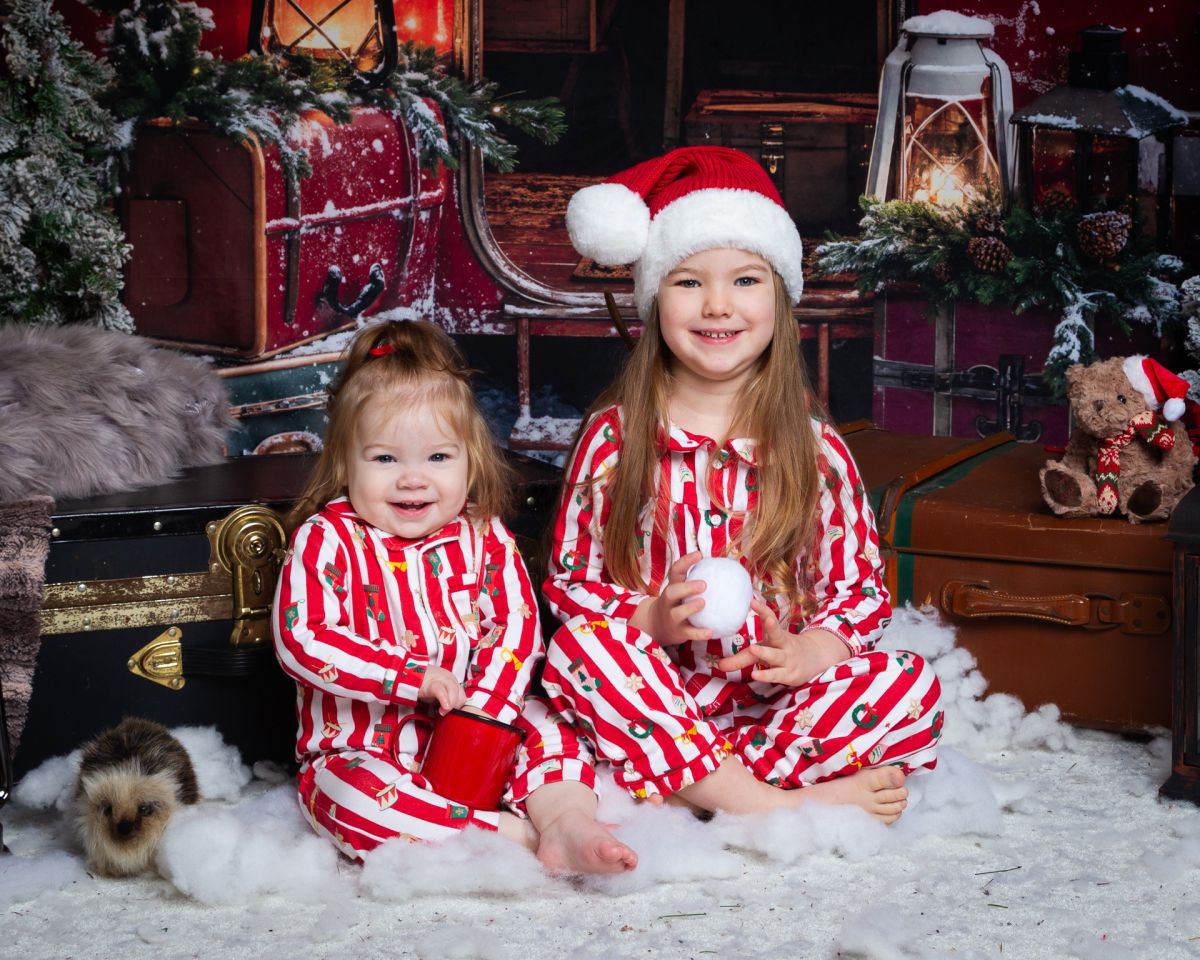 Christmas Photo Shoots West Sussex 2025 Children in matching pyjamas pose in a christmas themed set