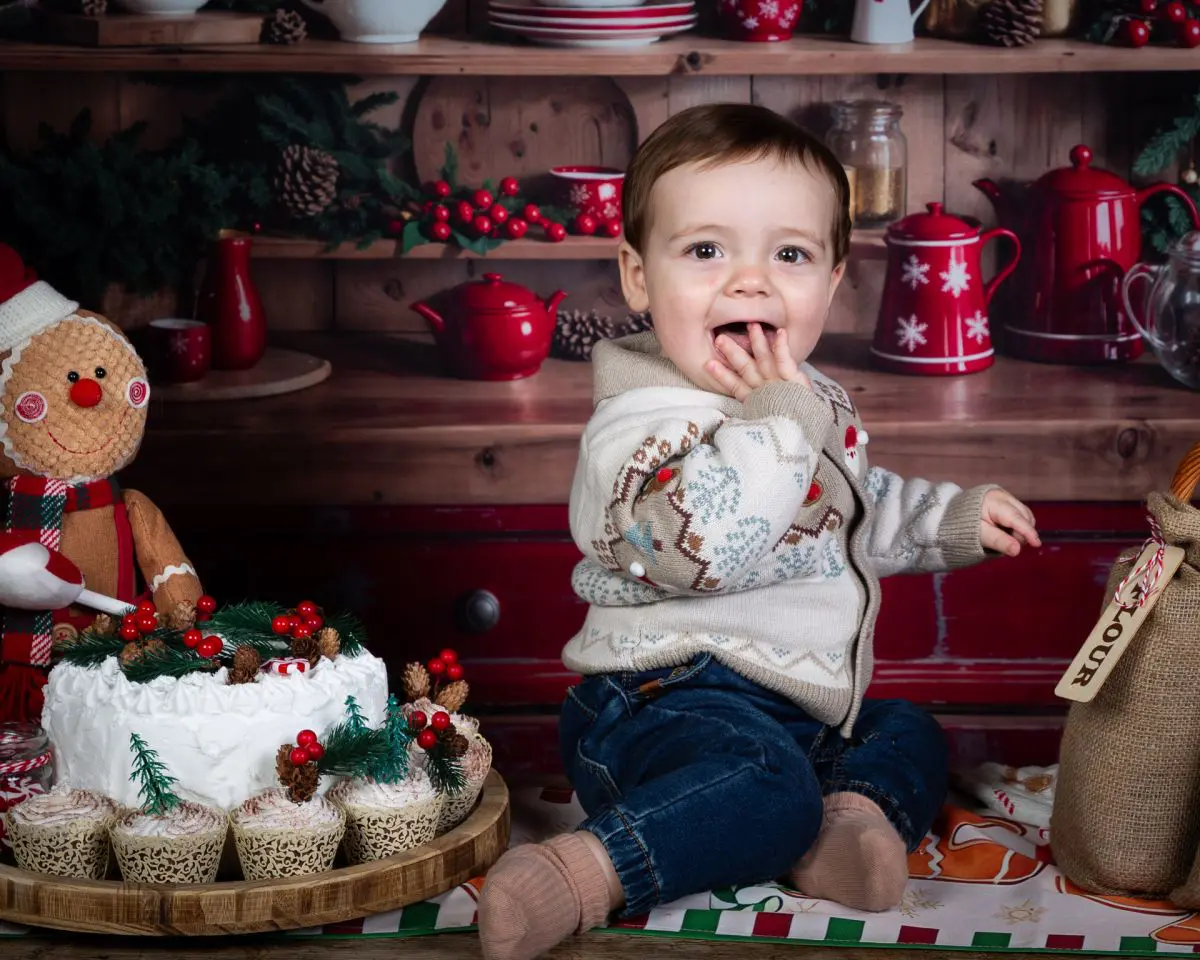 a baby strikes a pose in a christmas themed set